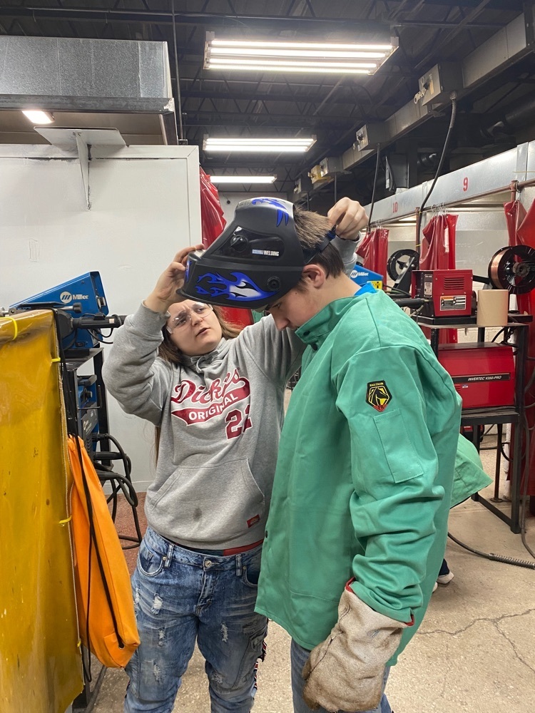 student getting fitted with welding gear