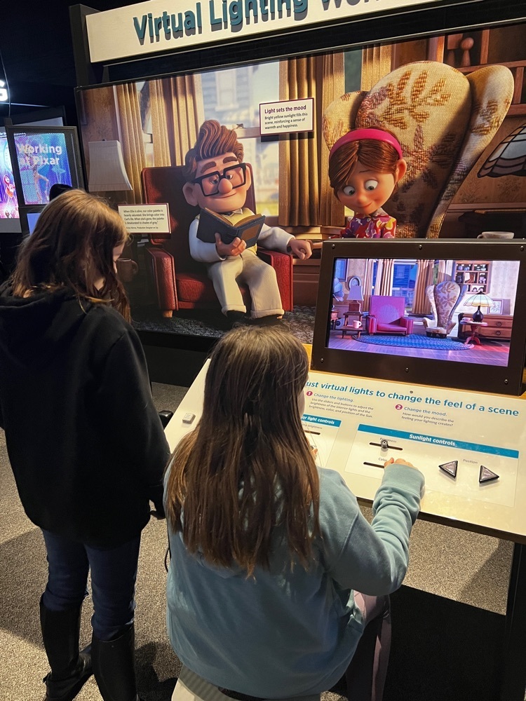 5th graders changing the lighting in the Pixar exhibit 